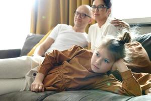 Happy family watching TV show at home photo