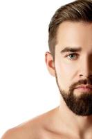 Young and handsome bearded man with smooth skin photo