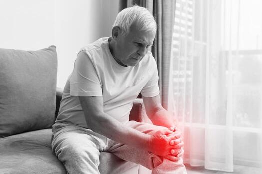 senior-man-suffering-from-pain-in-his-knee-at-home-photo.jpg