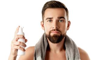 Handsome man with a cleansing or shaving foam photo