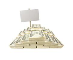 Stacks of One Hundred Dollar Bills on White with Blank Sign photo
