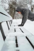 Athletic man doing push ups during his calisthenics winter workout photo