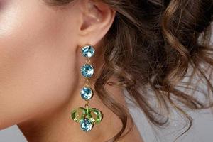 Woman is wearing beautiful and expensive earrings photo