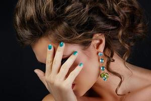 Woman is wearing beautiful and expensive earrings photo