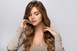 Portrait of young pretty woman with a curly hairstyle photo