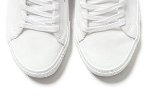 Pair of white leather trainers on white background photo