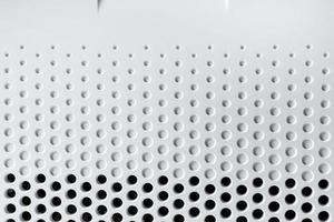 Abstract background hi-tech plastic surface with a holes and circles photo