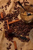 Roasted coffee beans and scoop with milled coffee photo