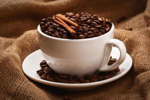 Cup filled with coffee beans photo