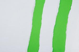 Torn paper on green background photo