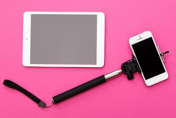 Smart phone on a selfie stick and tablet pc