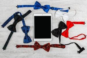 Different bow ties and tablet pc photo
