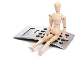 Small wooden dummy and calculator photo