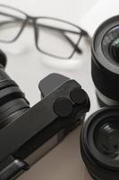 Workplace with a modern equipment for photography. Mirrorles camera and prime lenses. photo