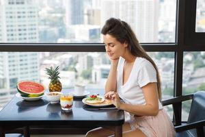 Young woman eating breakfast at the morning at home photo