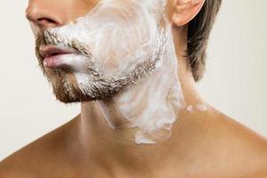 Man with a shaving cream on his face photo