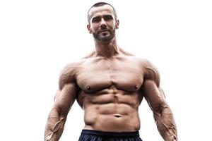 Muscular young man posing on white background photo