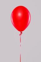 One red balloon isolated on gray background photo