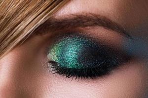 Close up of female eye with a green eyeshadow photo