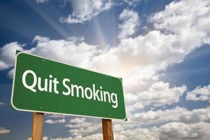 Quit Smoking Green Road Sign and Clouds photo