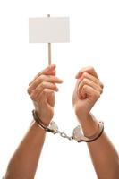 Handcuffed Woman Holding Blank White Sign Isolated on White photo