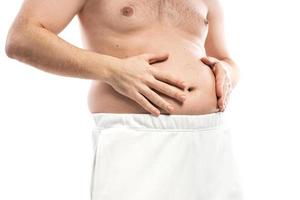 problema de sobrepeso o trastorno alimentario. hombre y vientre gordo. foto