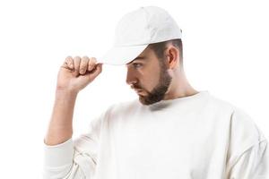 Handsome man wearing blank white cap on white background photo