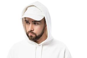 Handsome man wearing blank white cap and hoodie on white background photo