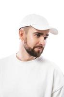 Handsome man wearing blank white cap on white background photo