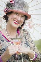 1920s Dressed Girl with Parasol and Glass of Wine Portrait photo