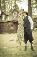 1920s Dressed Romantic Couple in Front of Old Cabin photo