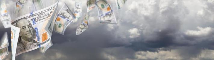 Several 100 Dollar Bills Falling From Stormy Cloudy Sky Banner photo