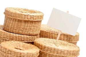 Various Sized Wicker Baskets with Blank Sign on White photo