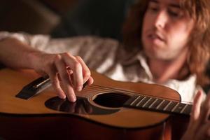 Young Musician Plays His Acoustic Guitar photo