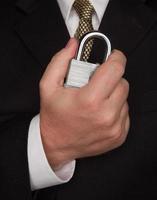 Businessman Holding Large Lock photo