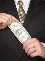 Businessman Holding Dollar Bill photo