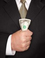 Businessman Squeezing Dollar Bill photo