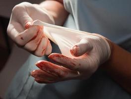 Abstract of Doctors Bloody Surgical Gloves photo