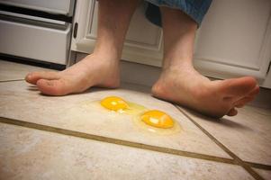 Eggs on the Floor at Man's Feet photo