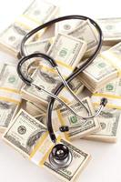 Question Mark Shaped Stethoscope Laying on Money photo