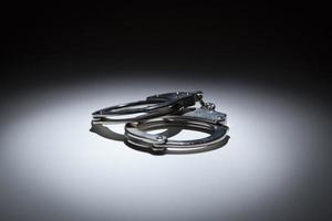 Abstract Pair of Handcuffs Under Spot Light photo