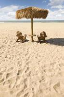 Two Beach Chairs and Umbrella on Beautiful Ocean Sand photo