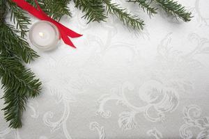 Silk Christmas Background with Candle and Pine Branches photo