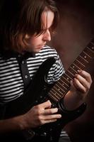 Young Musician Plays His Electric Guitar photo