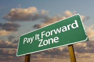 Pay It Forward Zone Green Road Sign and Clouds photo