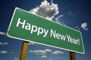 Happy New Year Road Sign with Dramatic Clouds photo