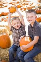 Two Boys at the Pumpkin Patch Talking and Having Fun photo