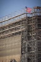 American Flag Flying on Top of New Building Construction photo