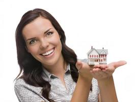 Smiling Mixed Race Woman Holding Small House Isolated on White photo