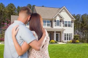 Military Couple Looking at Nice New House photo